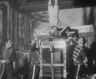 Houdini performing Water Torture Cell